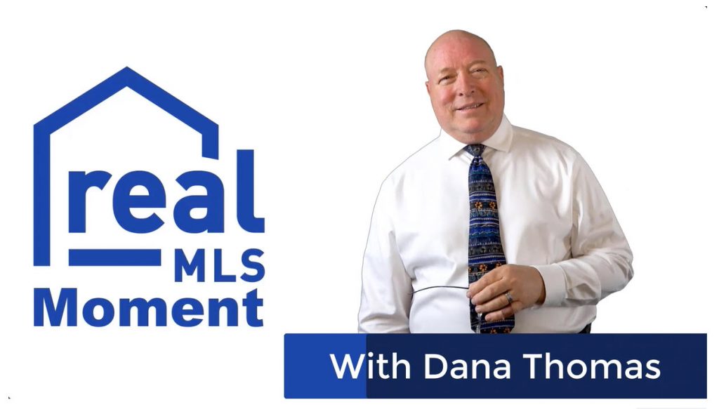 Professional Man named Dana Thomas Standing next to a Logo realMLS Moment