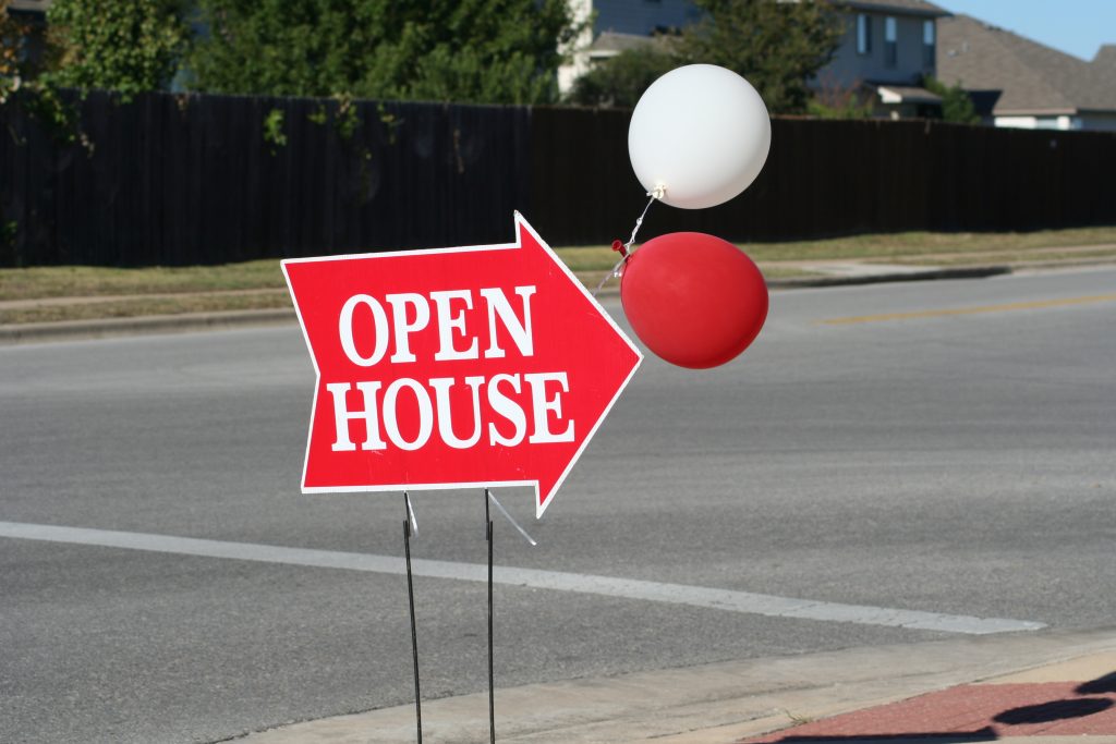 Open House Sign with Balloons on Side of Road