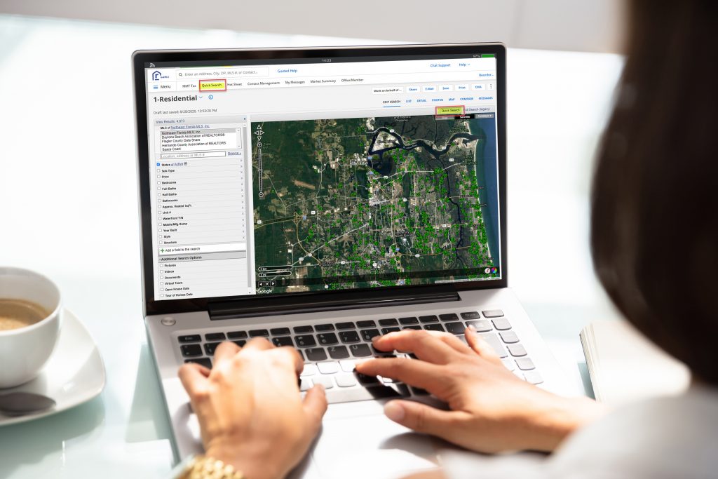 Woman typing on laptop with map aerial map on the computer screen