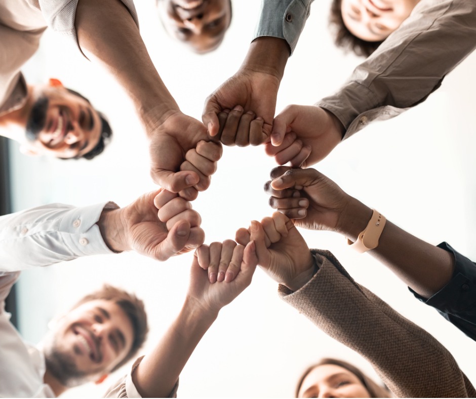 portrait-of-diverse-business-people-giving-fist-bump-in-cirle-